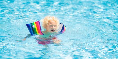 Child In Swimming Pool Kid With Float Armbands Stock Photo Image Of