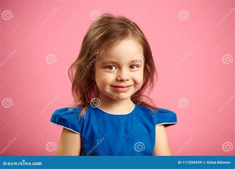 Portrait Of Beautiful Child Girl With Charming Look On Blue Background