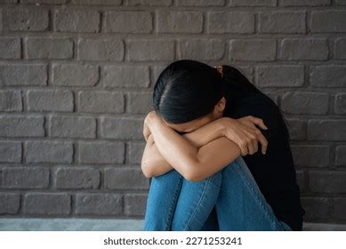 Depressing Woman Hugging Knees On Floor Stock Photo