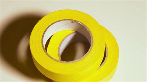 Yellow Sticky Tape Rotates On Gray Background Stock Footage Videohive