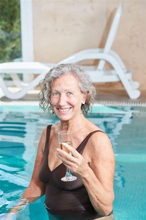 Senior Woman In The Pool With A Champagne Glass Stock Image Image Of