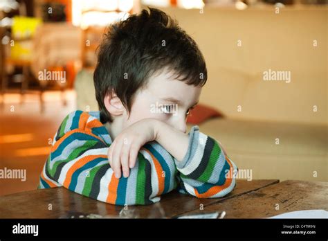 Little Boy Sulking Resting Head On Arms Stock Photo Alamy