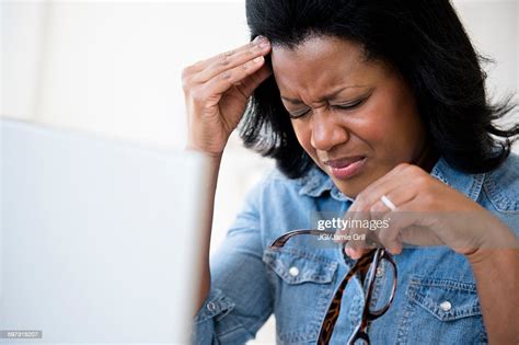 Frustrated Black Woman Rubbing Her Forehead Photo Getty Images