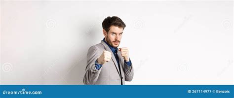 Serious Man In Suit Raising Hands In Boxer Pose Going To Fight