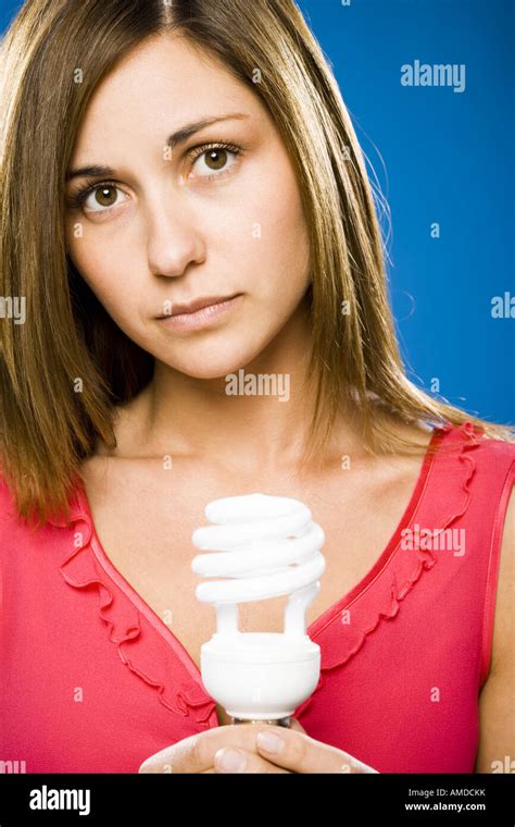 Woman Holding Energy Efficient Lightbulb Stock Photo Alamy