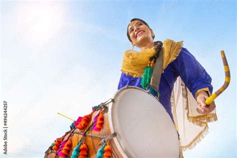 Portrait Of Sikh Woman Playing Drum During Baisakhi Celebration Stock