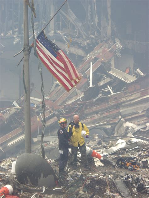 911 Rescue Workers Stand Next To The Antenna That Was Formerly Atop