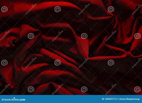 Dark Red Wrinkled Fabric With Lights Falling Into Patterns Stock Image