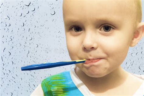 Little Boy Child Brushing His Teeth With A Toothbrush Stock Photo
