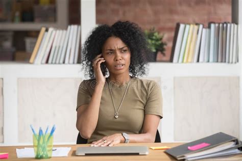 Frowning African Businesswoman Having Unpleasant Conversation On Phone