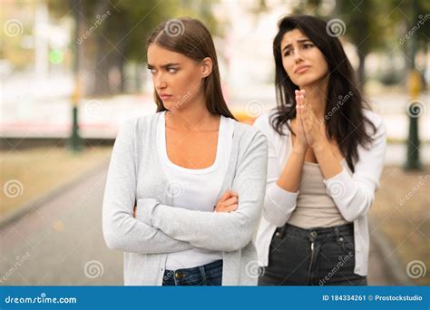 Girl Begging Offended Female Friend To Remain Friends Standing Outdoors Stock Image Image Of