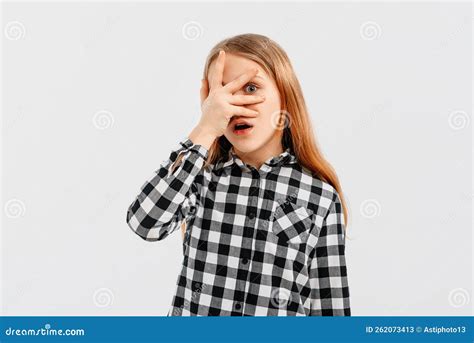Portrait Of Teen Girl Looking Shocked And Concerned Hiding Face Behind