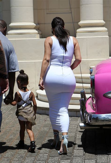 bootylicious kim kardashian exposes larger than ever butt in sexy skintight white dress