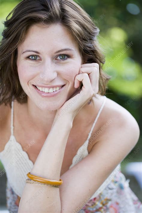 Smiling Woman Sitting Outdoors Stock Image F0051963 Science Photo Library