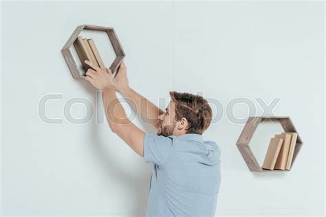 Young Man Hanging Wooden Shelf With Stock Image Colourbox