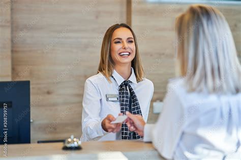 Receptionist And Businesswoman At Hotel Front Desk Foto De Stock Adobe Stock