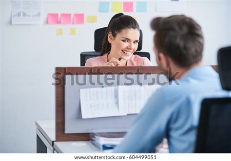 Office Flirt Attractive Woman Flirting Over Desk With Her Coworker Stock Image Everypixel