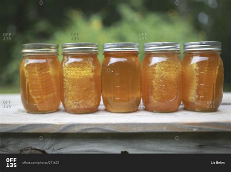 Fancy, elegant, jars, cute mason jars, pastel mason jars, girly, pretty mason jars, kawaii mason jars, lavender, lavenders, lavenders in mason jar. Mason jars of honey and honeycomb stock photo - OFFSET