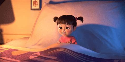 An Animated Doll Is Sitting On The Edge Of A Bed