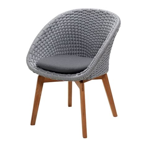 Gray cushioned seat is supported. Cane-line - Peacock Armchair Outdoor | Connox
