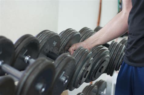 Man Pick Up Dumbbell Weight From Rack In Gym Stock Photo Image Of