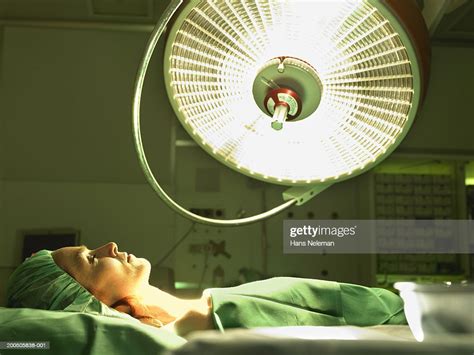 Female Patient Lying On Operation Table Beneath Light Photo Getty Images