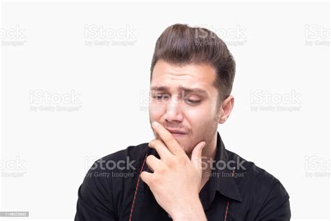 Portrait Of Sad Young Man Looking Away With Exhausted Facial Expression