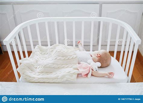 Because most beds aren't supposed to fit more than 2 adults. Baby Sleeping In Co-sleeper Crib Attached To Parents` Bed ...