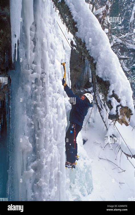 A Female Ice Climber Begins A Climb On A Frozen Waterfall At Pictured