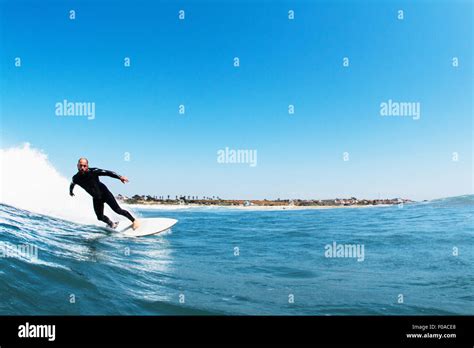 Surfer riding waves in ocean, California, USA Stock Photo - Alamy