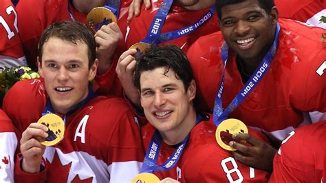 the canadian men s hockey team poses with their gold medals