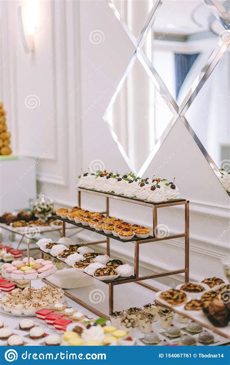 Beautifully Decorated Catering Banquet Table With Burgers Profiteroles