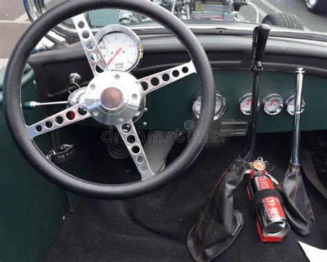 A Car Dashboard With Steering Wheel And Controls And Accessories
