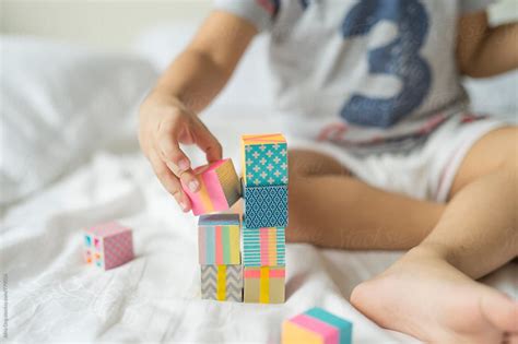 Kid Playing With Colourful Building Blocks By Stocksy Contributor