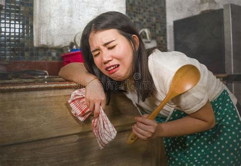 Young Tired And Stressed Asian Chinese Woman In Cook Apron Working