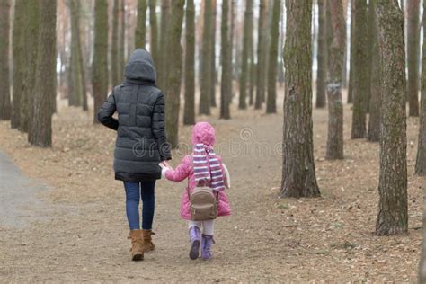 Mom And Daughter Are Walking Around The Park In The Hand Stock Photo