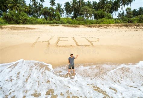 Man Stuck On Uninhabited Island Inscription Help On Sand Stock Image