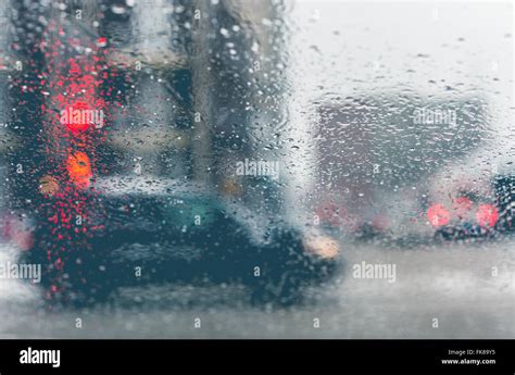 Road View Through Car Window With Rain Drops And Melting Snow Driving