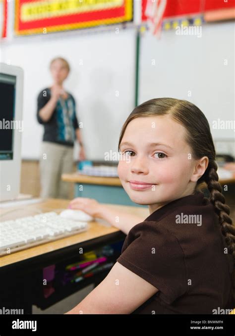 Elementary Student Sitting At Desk In Classroom Stock Photo Alamy