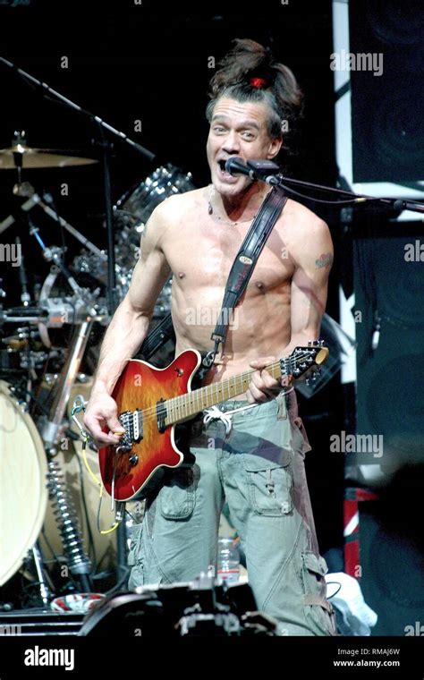 Guitarist Eddie Van Halen Is Shown Performing On Stage During A Live