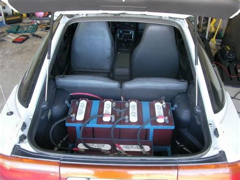 The Back End Of A Car With Two Suitcases In Its Cargo Compartment
