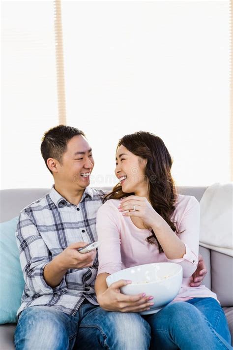 Happy Man Looking At Woman While Sitting On Sofa Stock Image Image Of