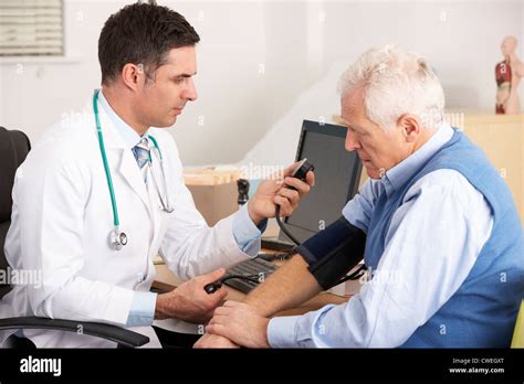 American Doctor Taking Senior Mans Blood Pressure Stock Photo Alamy