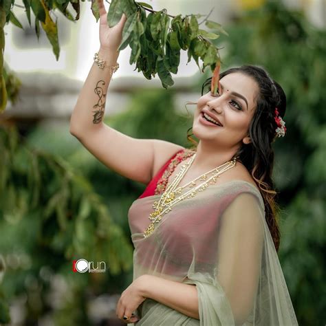 Actress And Singer Rimi Tomy Photos