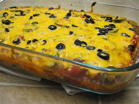 A chicken enchilada casserole with layers and layers of cheese. Layered Enchilada Casserole | Tasty Kitchen: A Happy ...