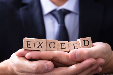 Businessman Holding Exceed Expectations Word Stock Photo Download