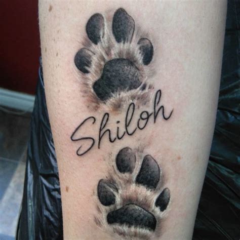 30+ best dog paw tattoos. The Paws Of The Dogs Are Being Tattooed On Their Owners ...
