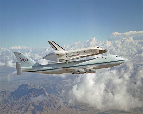 The Nasa Space Shuttle Being Transported Atop The Nasa Modified Boeing