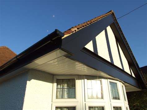 The oak soffit sweeps upwards at the existing house, revealing a frameless glass opening to sky allowing daylight into the heart of the house. Installation of Black Mock-Tudor UPVC Fascias, Soffits ...
