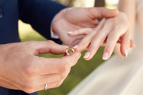 Premium Photo Man Putting A Wedding Ring On A Woman Finger